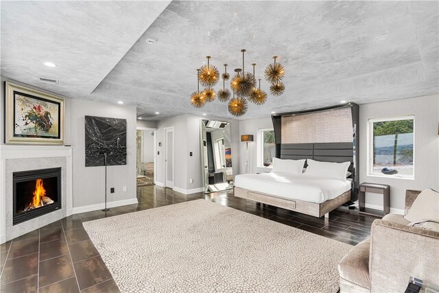 bedroom featuring ensuite bathroom and dark wood-type flooring