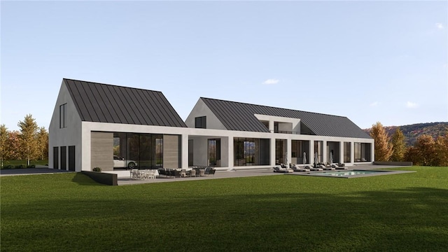 back of house featuring a pool, a yard, and a patio