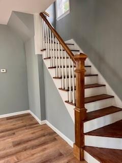 stairs featuring wood-type flooring