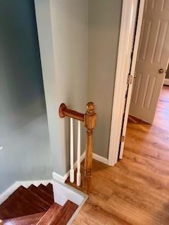 stairs featuring wood-type flooring