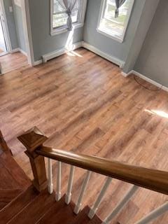 stairs with wood-type flooring and wood walls