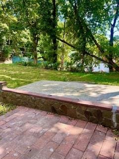 view of storm shelter with a patio area