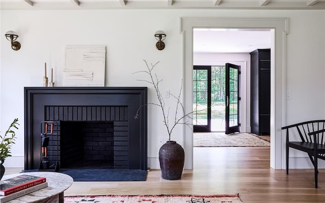 living room featuring hardwood / wood-style floors and beam ceiling