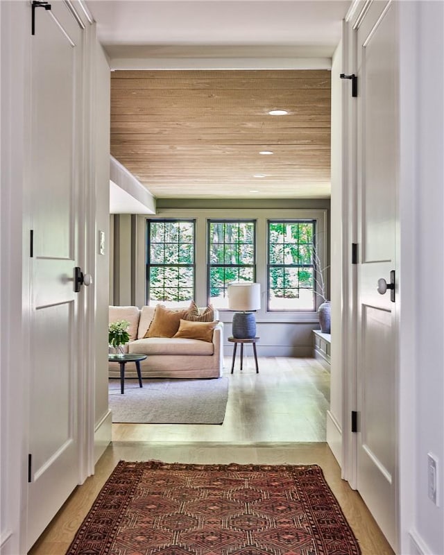 interior space featuring light hardwood / wood-style floors and wood ceiling