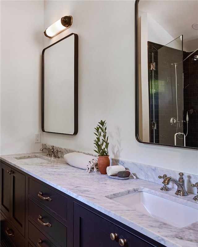 bathroom with vanity and a shower with door