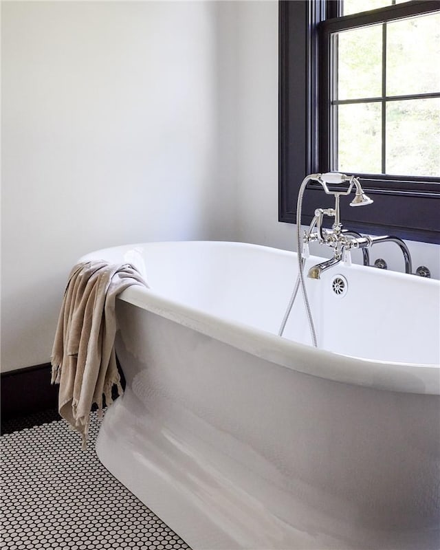 bathroom with tile patterned floors and a bathing tub