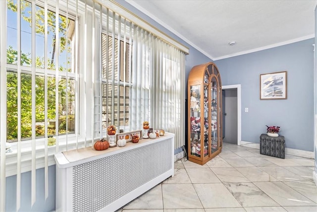 corridor with a healthy amount of sunlight, light tile patterned floors, and crown molding