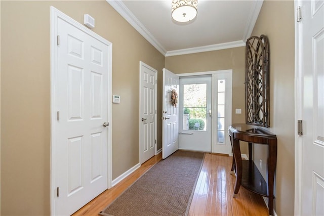 entrance foyer with hardwood / wood-style floors and ornamental molding