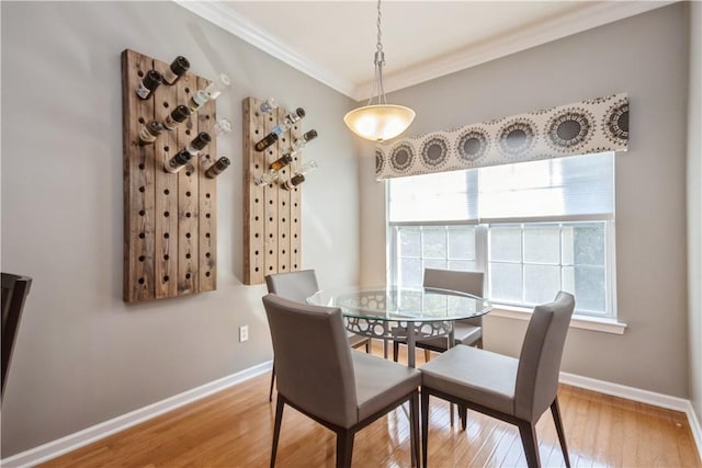 dining room featuring hardwood / wood-style flooring and crown molding