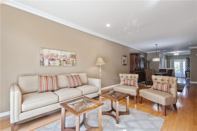 living room with french doors, hardwood / wood-style flooring, and ornamental molding