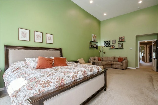 carpeted bedroom featuring high vaulted ceiling