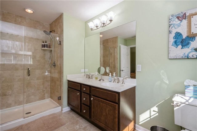 bathroom featuring tile patterned flooring, vanity, and a shower with shower door