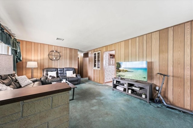 carpeted living room featuring wooden walls