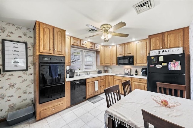 kitchen with black appliances, ceiling fan, and sink