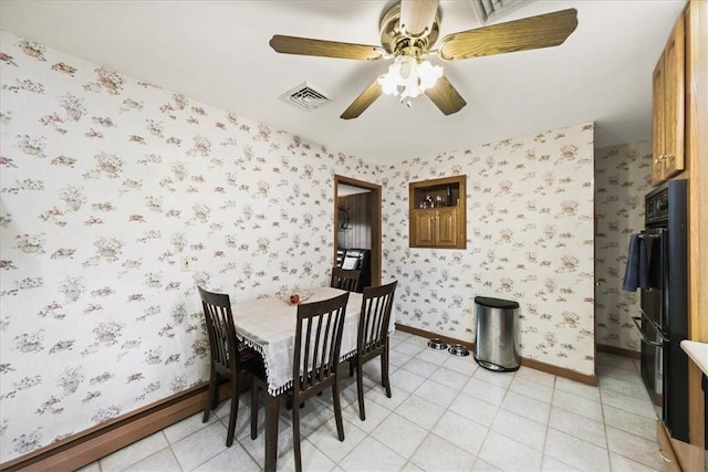 dining area featuring ceiling fan and light tile patterned flooring