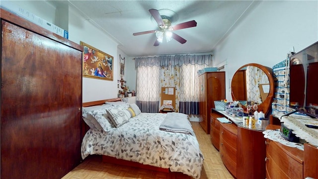 bedroom featuring ceiling fan and light parquet floors