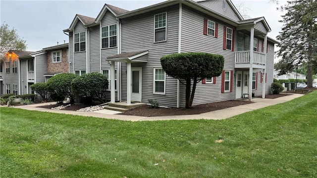 rear view of property with a yard