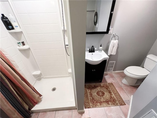 bathroom with tile patterned floors, a shower with curtain, toilet, and vanity