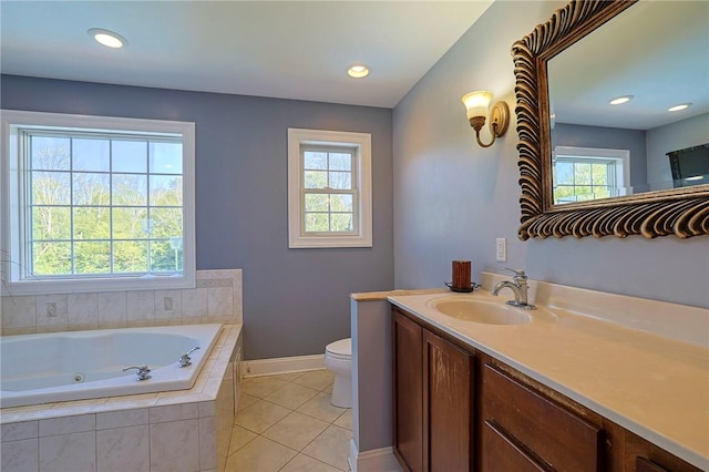 bathroom with toilet, vanity, a relaxing tiled tub, and tile patterned floors