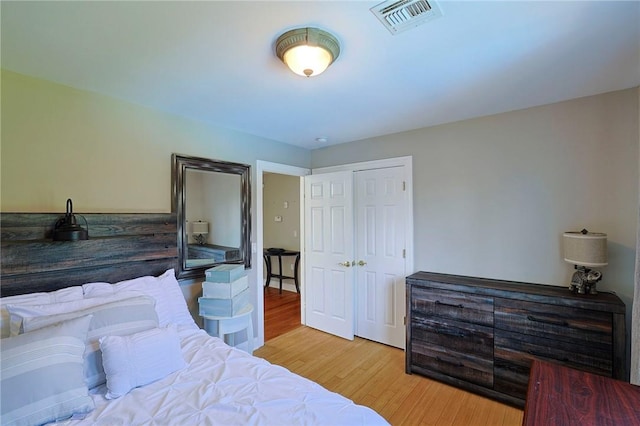 bedroom featuring light wood-type flooring and a closet