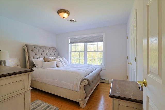 bedroom featuring light hardwood / wood-style floors and a baseboard radiator