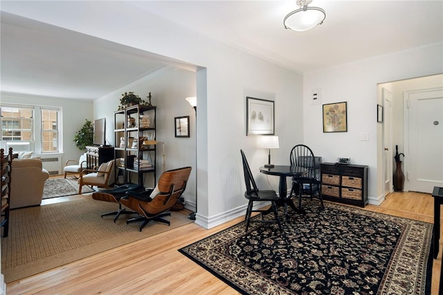 home office with hardwood / wood-style flooring and ornamental molding