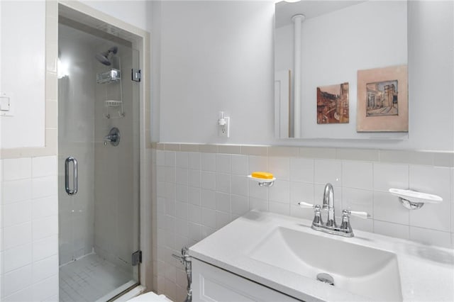 bathroom featuring vanity, tile walls, and walk in shower