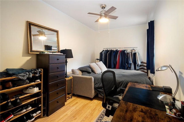 bedroom with light hardwood / wood-style flooring and ceiling fan