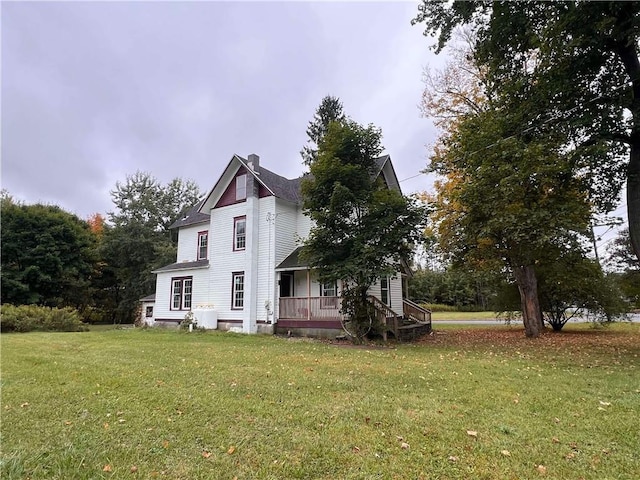 exterior space featuring covered porch and a lawn