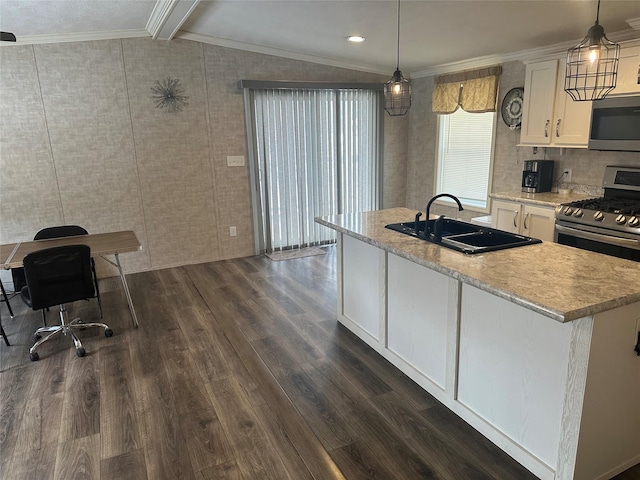 kitchen featuring pendant lighting, lofted ceiling with beams, sink, and stainless steel appliances