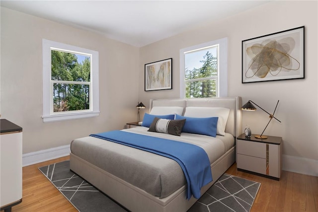 bedroom featuring wood-type flooring and multiple windows