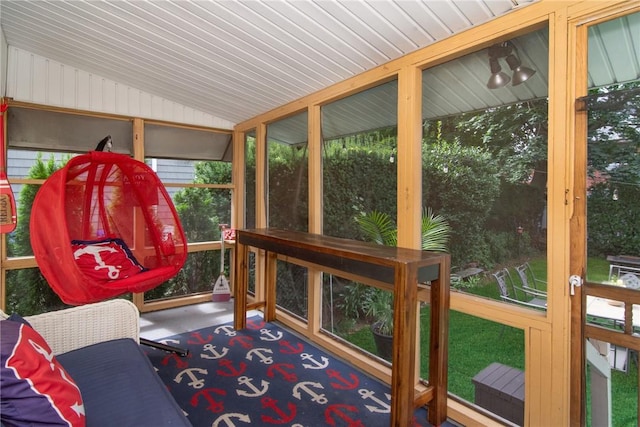 sunroom / solarium featuring vaulted ceiling