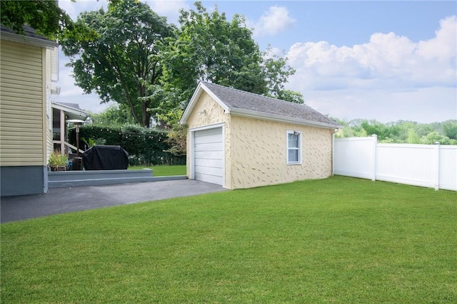 garage featuring a lawn