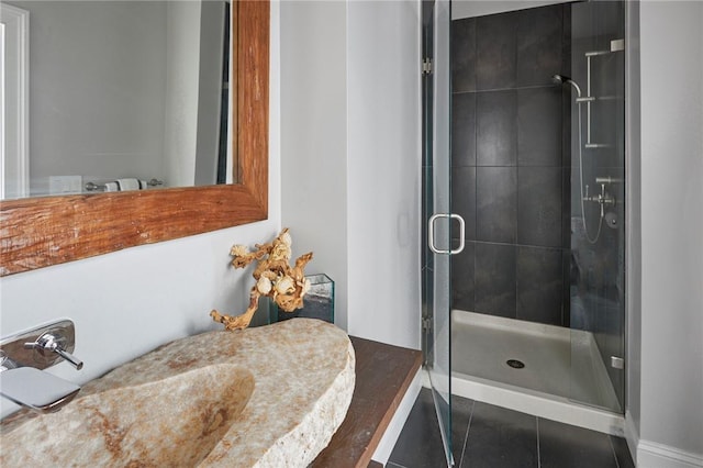 bathroom with tile patterned floors and an enclosed shower