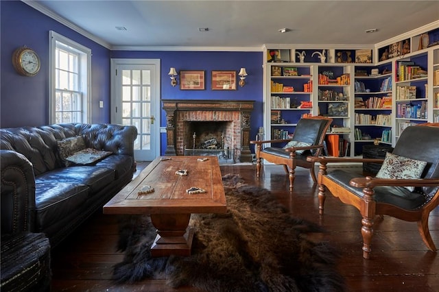 living room with hardwood / wood-style flooring, crown molding, and a brick fireplace