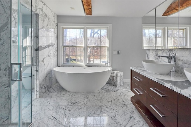 bathroom featuring shower with separate bathtub, vanity, and tile walls