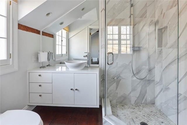 bathroom featuring hardwood / wood-style floors, vanity, a healthy amount of sunlight, and walk in shower