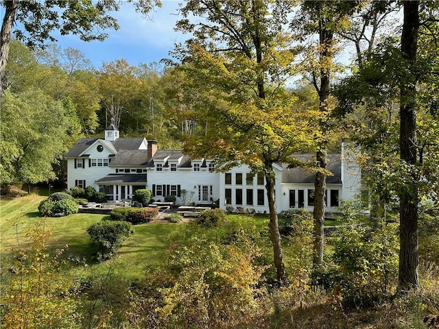 back of house featuring a lawn