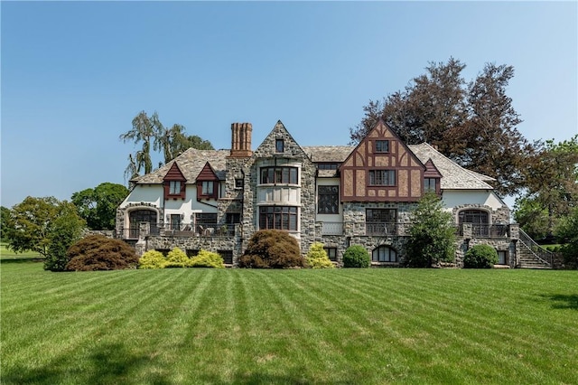 rear view of property with a yard