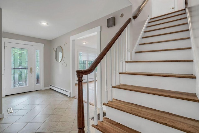 tiled entryway with a baseboard radiator