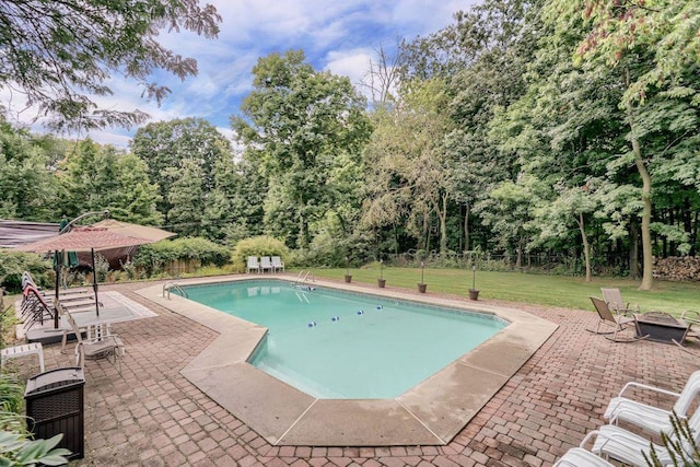 view of swimming pool featuring a yard and a patio