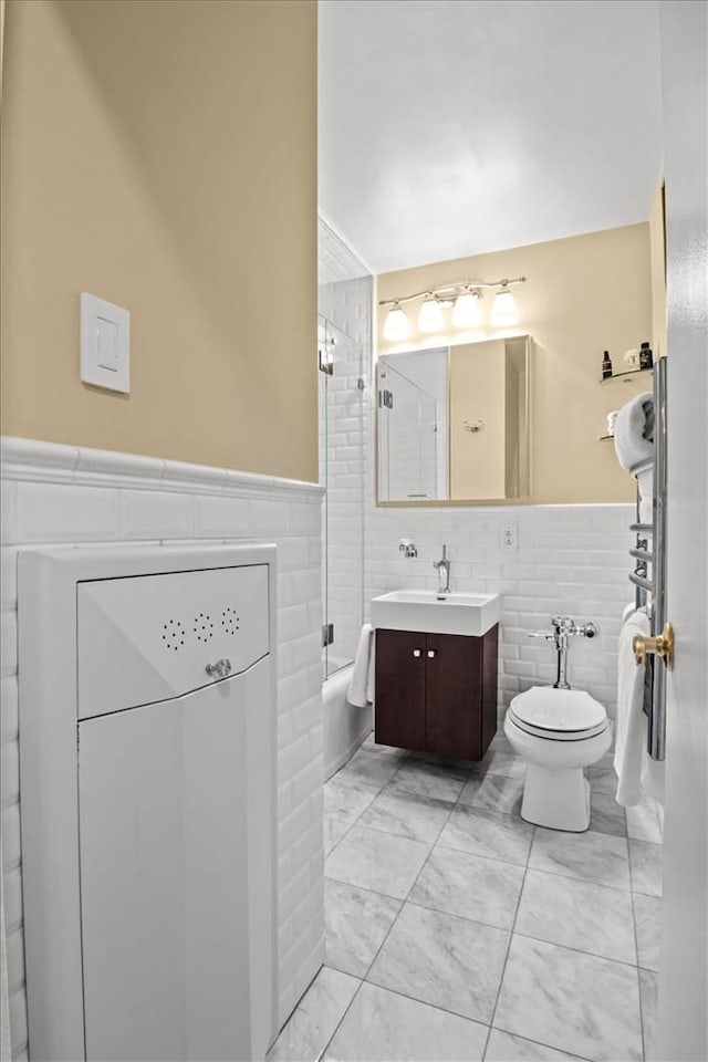 2575 Palisade Ave Unit 2G, Bronx, NY 10463 - bathroom featuring a wainscoted wall, vanity, tile walls, toilet, and marble look tiles