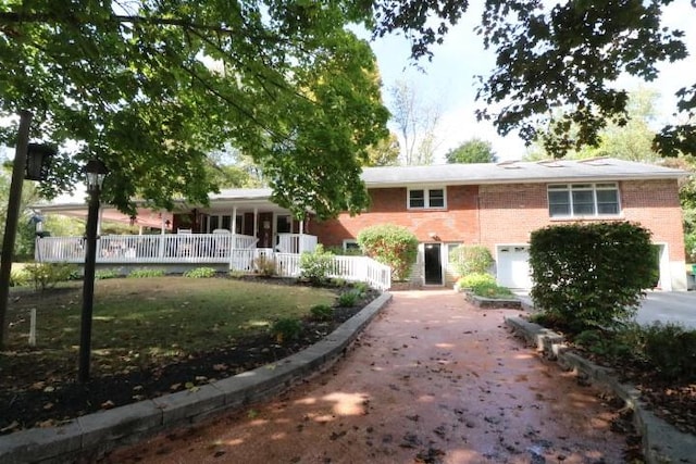 exterior space with a garage and a lawn