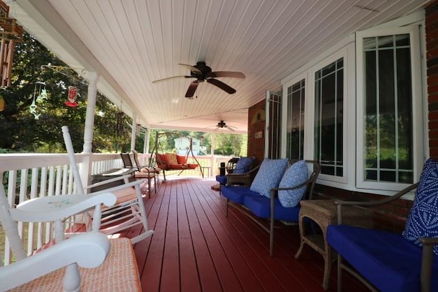 wooden deck featuring ceiling fan and a porch