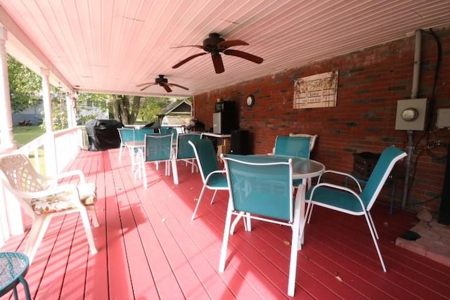 deck with grilling area and ceiling fan