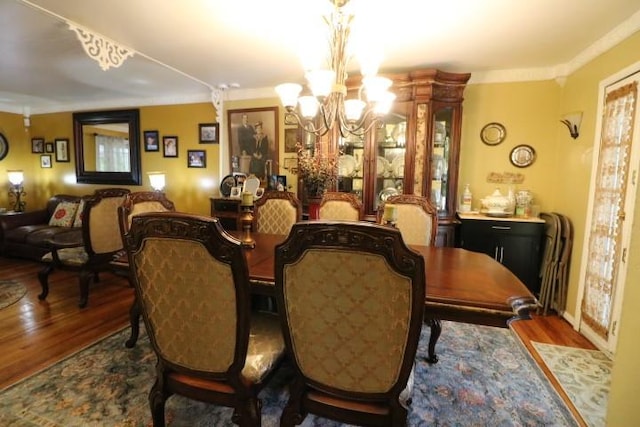 dining room with dark wood-type flooring and a chandelier