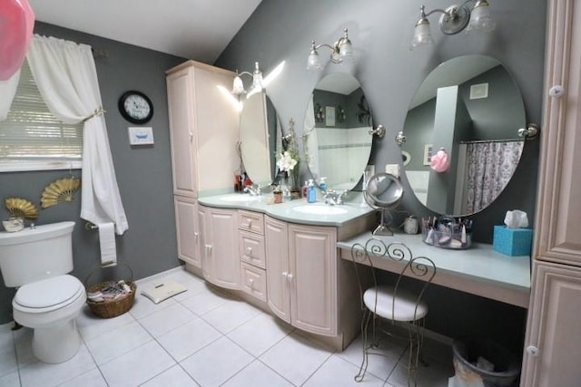 bathroom with tile patterned flooring, vanity, toilet, and lofted ceiling