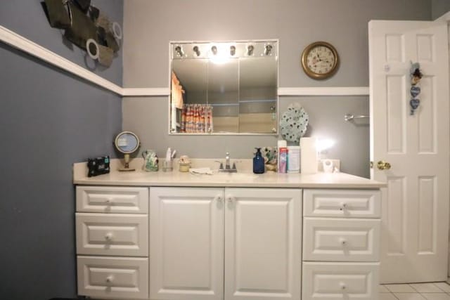 bathroom with tile patterned floors and vanity