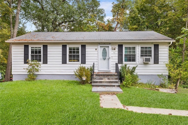 ranch-style home with cooling unit and a front yard