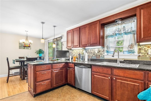 kitchen featuring backsplash, a wealth of natural light, dishwasher, and sink